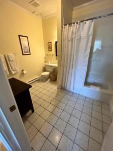 a bathroom with a shower and a toilet and a sink at Kelly's Landing in Trinity +25 photos