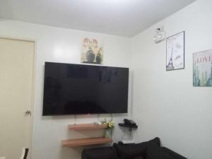 a flat screen tv on a wall in a living room at Seawind Condominiums Tower 1,3,4,5 in Davao City
