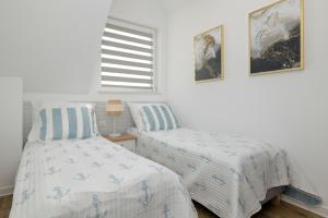 Postel nebo postele na pokoji v ubytování Akwamaryn Apartamenty