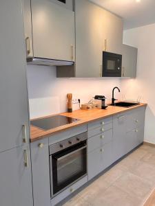 a kitchen with a sink and a stove top oven at Nice flat Paris Clichy in Clichy +5 photos