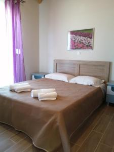 Postel nebo postele na pokoji v ubytování Havouli Cottage