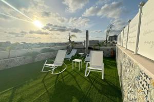 a group of chairs and tables on a balcony at Casa MarFe in Grottaglie