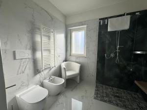 a bathroom with a toilet and a sink and a shower at Casa MarFe in Grottaglie