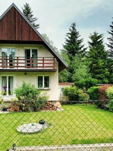 a house with a fence in front of a yard at Randy's House Plzeň in Pilsen