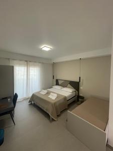 a bedroom with a bed and a flat screen tv at Soraya Rooms Tropea in Tropea