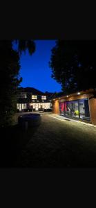 a building lit up at night with lights at Bramble Close in Chalfont Saint Peter