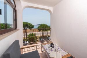 a balcony with a table and a view of the ocean at Blu infinito Apartment&studios in Rovinj