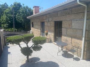 eine Terrasse mit Tisch und Stühlen und ein Gebäude in der Unterkunft A Quinta do Presidente 