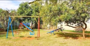 a playground with colorful swings in a yard at JM03 Apartamento com Ar Condicionado e Garagem in Dourados +5 photos