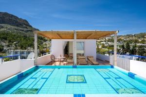 a swimming pool on the roof of a house at Exquisite Retreat For Two in Archangelos