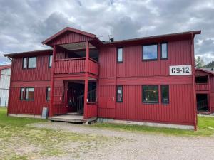 a red building with a number on it at Lassiebyn 10 Entire Apartment with Parking & Kitchen in Branäs