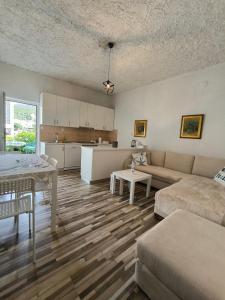 a living room with a couch and a table at Apartman Zora in Neum