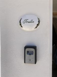 a clock on a wall with the word familia on it at Trullo Moi in Ostuni