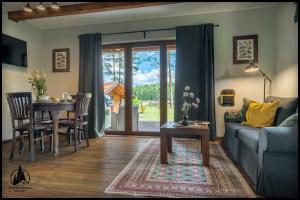 a living room with a couch and a table at Hankówka Mazury in Jerutki