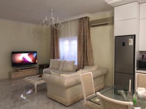 a living room with a couch and a television at Muhtadir in Xudat