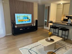 a living room with a flat screen tv on a table at Beautiful 1 bedroom apartment in Paris 17 - Clichy in Clichy