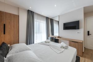 Postel nebo postele na pokoji v ubytování Sea La Vie Suites