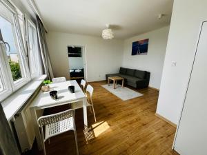 a living room with a table and chairs and a couch at Cliff Apartment Redłowo in Gdynia