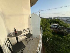 a small patio with a table and chairs on a balcony at Vila Olserd Shehu in Ksamil +37 photos