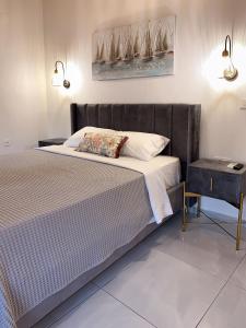 a bedroom with a bed and a side table at Thetis, the Beach House in Nafplio