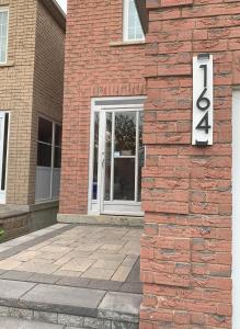 a brick building with a sign on the side of it at Contemporary Private Basement Suite in Markham