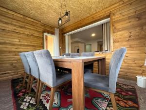 a dining room with a wooden table and chairs at Happy House in Sarajevo