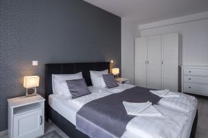 A bed or beds in a room at Aranymandula apartmanok