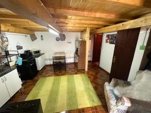 a living room with a couch and a kitchen at Casa da Eira - Portugal Profundo in Vila Pouca de Aguiar