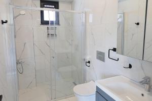 a bathroom with a shower and a toilet and a sink at Orkide Sapanca in Sapanca +9 photos