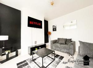 a living room with a couch and a table at 5 Bedroom House-20 percent off monthly stays in Neepsend