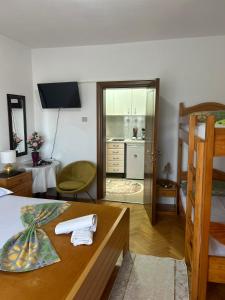 a bedroom with a bed and a living room at Apartments Gazi in Ulcinj