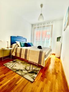 ein Schlafzimmer mit einem großen Bett mit einem Teppich in der Unterkunft O Lar de Raxó in Raxo