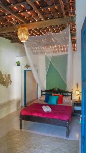 En eller flere senge i et værelse på Casamor Café e Hospedaria Praia de Algodões + 9 billeder