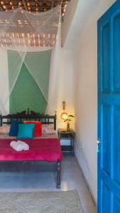 En eller flere senge i et værelse på Casamor Café e Hospedaria Praia de Algodões