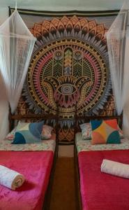 En eller flere senge i et værelse på Casamor Café e Hospedaria Praia de Algodões