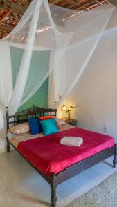 En eller flere senge i et værelse på Casamor Café e Hospedaria Praia de Algodões