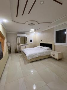 a bedroom with a large white bed and a ceiling at Villa nador in Nador +8 photos