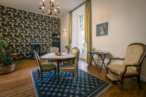 a dining room with a table and chairs at Le Prieuré Sainte Croix in Loudun