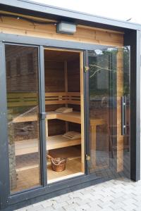a glass extension to a house with a glass door at Pod křídly Krkonoš in Černý Dŭl