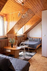 a bedroom with a bed and a table in a room at SunRise Mielno in Mielno