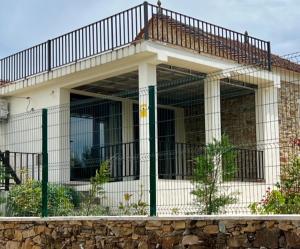 a house with a balcony on top of it at Casa de Pedra in Pedrógão Grande