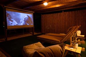 a living room with a large screen with a couch at Falasarna Caravans in Falasarna