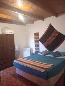 a bedroom with a bed with a mosquito net on it at Hostal Open House in San Pedro de Atacama