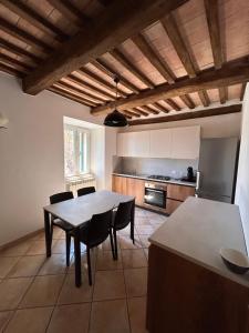 a kitchen with a table and chairs in a room at La casina di Montemerano in Montemerano