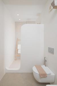 a white bathroom with a toilet and a shower at Casa di Grazia in Naxos Chora +31 photos