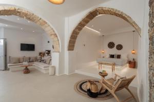 a living room with an archway and a bedroom at Casa di Grazia in Naxos Chora
