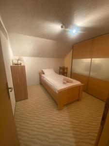 a small bedroom with a bed and a cabinet at Forest House between Sarajevo & Vlasic in Busovača