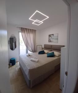 a bedroom with a large bed with blue pillows at Apartment Milan in Boreti
