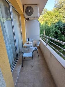 a balcony with a table and chairs on it at Apartment Milan in Boreti