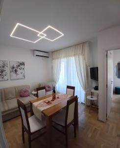 a living room with a table and a couch at Apartment Milan in Boreti